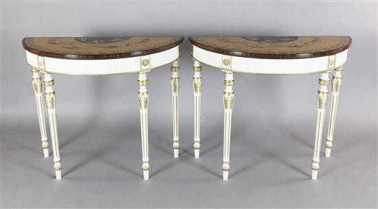 A pair of Adam revival painted and parcel gilt demi lune console tables, W.3ft 3in. D.1ft 6in. H.2ft 8in.